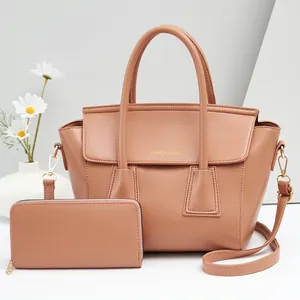 Detail of powder pink handbag set with gold hardware and removable shoulder strap
