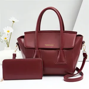 Detail of burgundy PU leather two-piece set including handbag and matching zip wallet