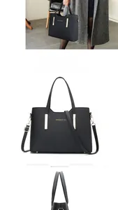 Détail du sac à main en cuir grainé noir avec poignées dorées et bandoulière réglable