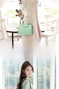 Detail of mint green quilted crossbody bag with gold metal handle and deer charm