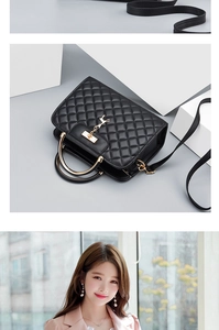 Detail of black quilted leather bag featuring a gold deer pendant and metal handle