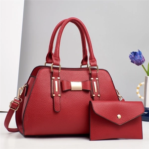 Red litchi grain tote bag with bow detail and matching pouch, elegant two-piece set