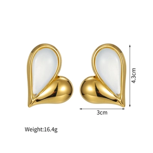 Detailed view of gold asymmetrical heart earrings showing 4.3cm height and 3cm width measurements