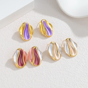 Three pairs of irregular gold and silver enamel earrings with organic artistic design