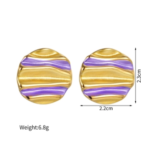 Detail showing wavy 18k gold irregular round earrings with purple enamel stripes