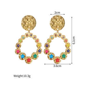Detail view of 18k gold hollow earrings with colorful enamel stars and measurements