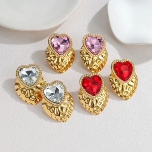 Three pairs of vintage heart-shaped earrings with colorful zircons and gold-plated finish