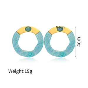 Detail of 4cm gold geometric earrings with green stone and blue mosaic texture resin