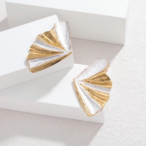 Modern two-tone 18k gold fan-shaped stud earrings with pleated texture on a white pedestal
