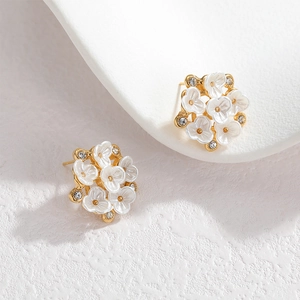 Elegant 18k gold floral earrings with white petals and sparkling crystal accents