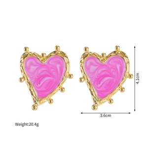 Detailed size view of large pink heart studs with gold embossed edges and enamel