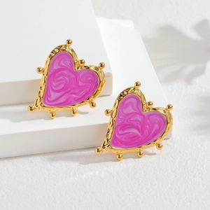 Pink marble heart stud earrings with 18k gold beaded edges on white display pedestals