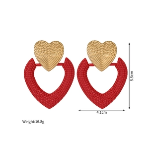 Detailed view of heart-shaped drop earrings with size 4.1x5.5cm and hammered texture