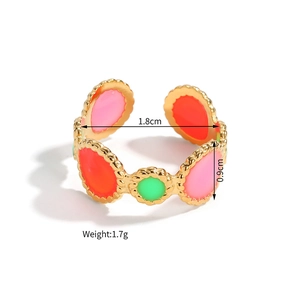 Detailed view of gold 18k plated open ring with pink red and green enamel circles