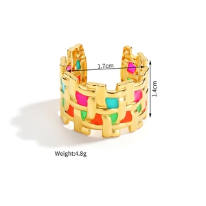 Macro view of woven gold ring with colorful enamel inlay showing 1.4cm width detail