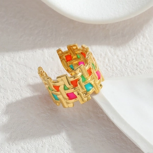 Chic 18k gold woven texture ring with colorful enamel dripping on a white background