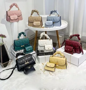 Detailed view of women's crossbody bag set with cloud handles and grid patterns