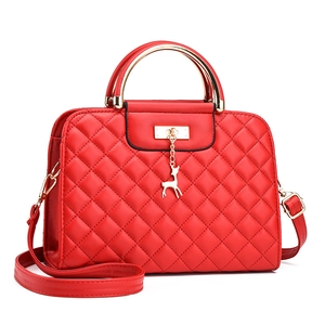 Quilted red crossbody handbag with golden metal handle and elk pendant charm