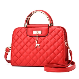 Elegant red quilted shoulder bag with gold deer charm and metallic handle strap