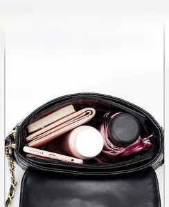 Detail view of the spacious quilted bag interior showing compartments and items