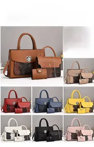 Detailed view of three-piece set with crocodile embossed tote, crossbody bag, and wallet