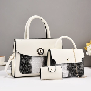 Detailed set of three beige handbags with snakeskin texture and camellia metal buckle