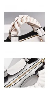 Close-up of woven leather handle and gold hardware zipper on white shoulder bag