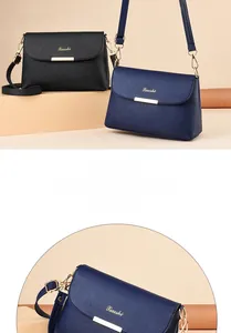 Detailansicht der Lychee-Lederstruktur und Goldverzierung an eleganten quadratischen Taschen