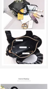 Detail view of large capacity bag interior with embroidery and organized compartments