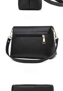 Detailansicht der schwarzen Tasche mit Litschi-Maserung, Goldbeschlägen und Rücktasche
