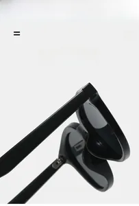 Detail view of lightweight black sunglasses featuring flexible frames and metal hinges