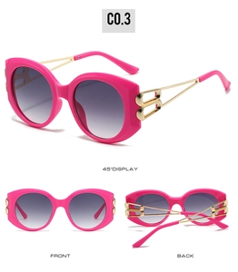 Detail of pink cat-eye sunglasses featuring gold-tone metal temples and B-shaped hinge design