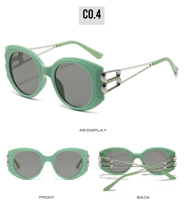 Detail view of oval sunglasses with green frames and B-shaped silver metal hinges