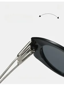 Detailed close-up of a durable silver metal hinge on oversized black oval sunglasses