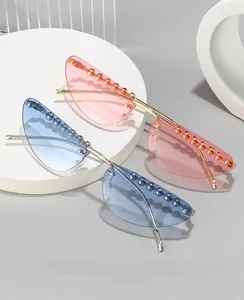 Macro shot of rimless cat-eye sunglasses with decorative beads and metallic frames