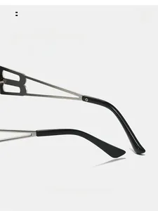 Detail of silver hollow B-letter temple design on black oval fashion sunglasses