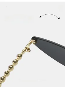 Detail view of durable golden metal hinges and beaded temples on cat eye sunglasses
