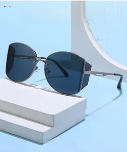 Detail of blue polygonal lenses with silver metal frame and hollowed temples of sunglasses