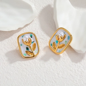 French vintage gold square studs with tulip flower and pearl inlay on a white base