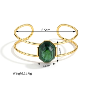 Detail of 18k gold hollow line bracelet with hexagonal green malachite stone inlay