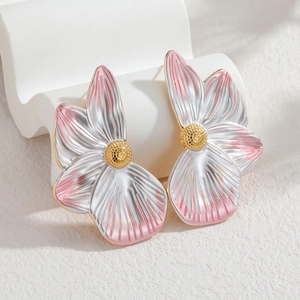 Stereo floral stud earrings in pink silver gradient with golden center on white stand