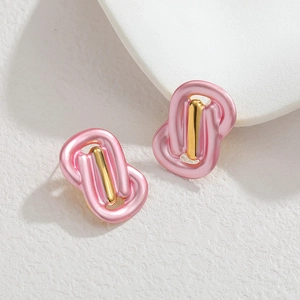 Irregular woven knot earrings with 18k gold center on elegant white marble base