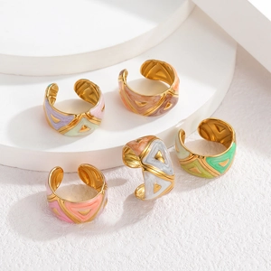 Detail of colorful enamel drip glaze on 18k gold plated stainless steel open rings