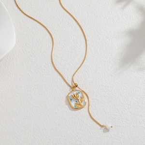 18k gold plated tulip necklace with white enamel inlay and pearl detail on a snake chain