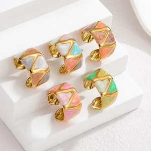 Detail view of 5-piece gold geometric rings with colorful enamel marble texture inlay