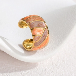 Macro shot of 18k gold plated ring with orange and pink marble enamel texture detail