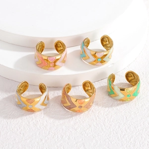 Detailed close-up of wide enamel open rings with geometric patterns in five vibrant colors