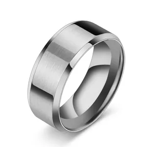 Detailed view of wide silver-colored stainless steel ring with polished beveled edges