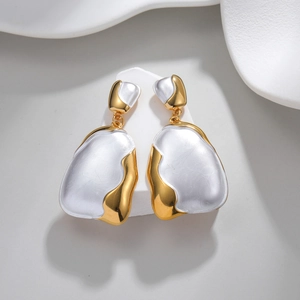 Irregular geometric earrings with 18k gold plating and pearlescent white enamel finish