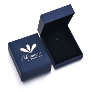 Close-up of deep blue pendant jewelry boxes with soft black velvet interior and logo